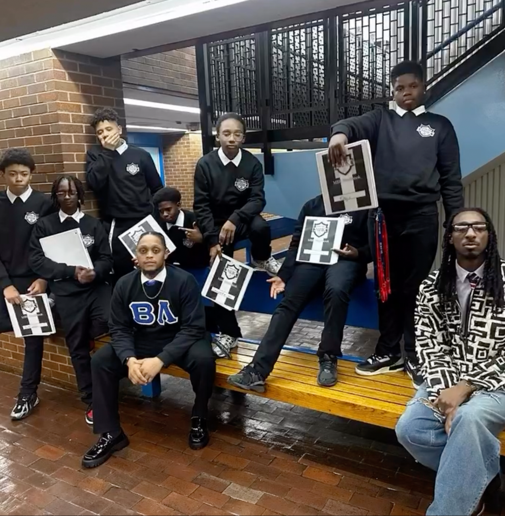 Scholars in school uniforms holding folders
