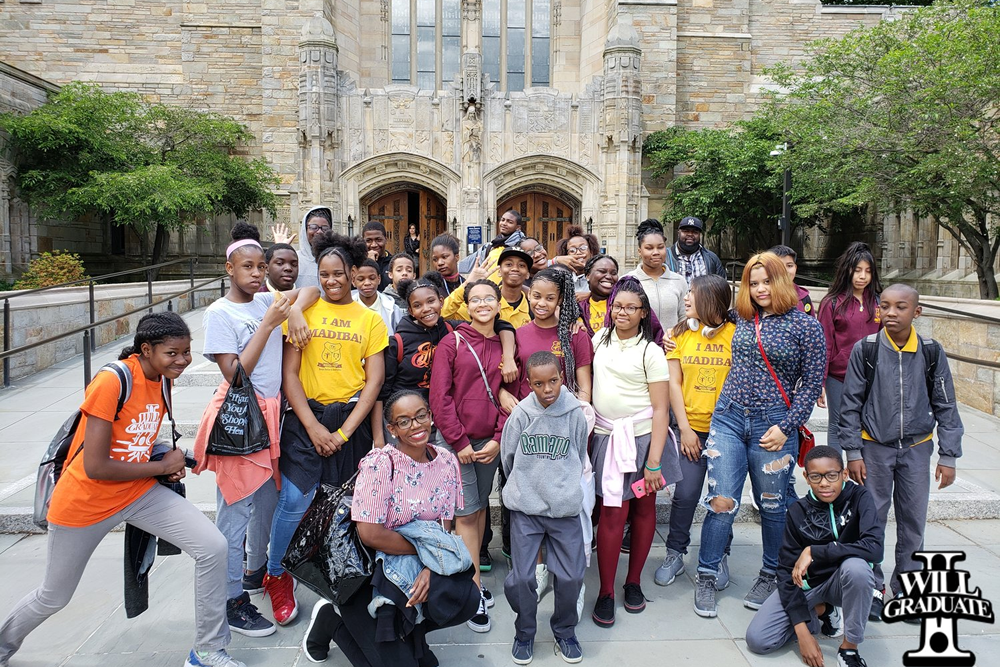 Madiba Prep scholars and staff gathered outside a university building.